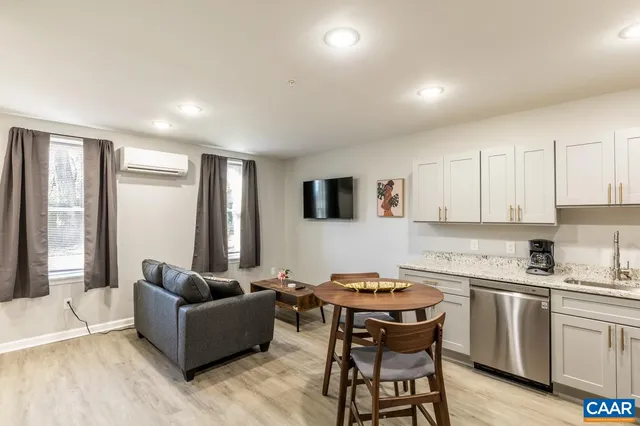 a living room with furniture and a wooden floor