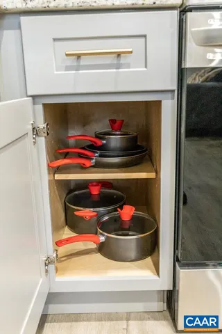 a utility room with a stove and cabinets