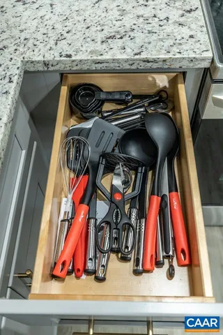 a view of walk in closet with clothes