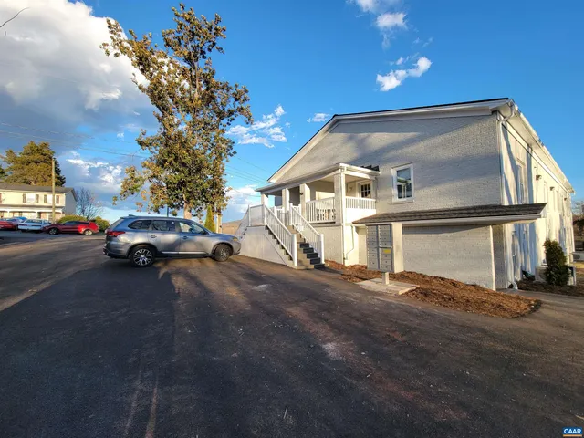 a view of a street with a car parked on the road