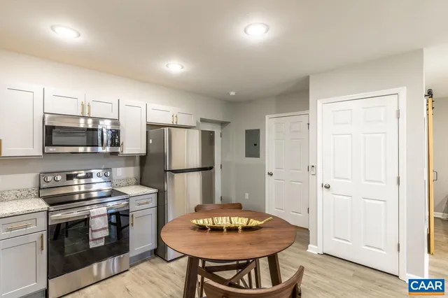 a kitchen with stainless steel appliances a stove a refrigerator and a refrigerator