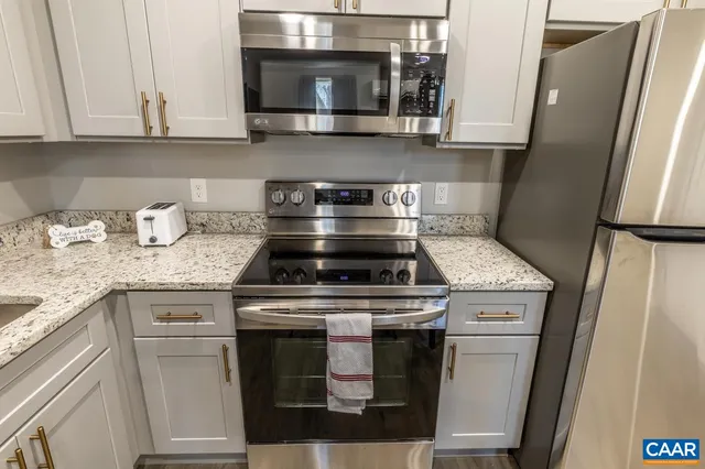 a stove top oven sitting inside of a kitchen