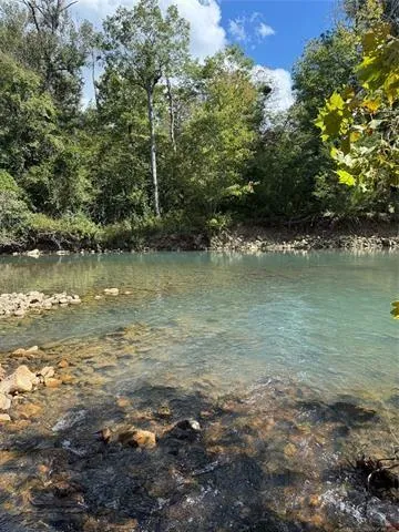 a view of a field with an trees in the background