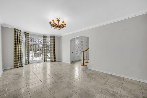 a view of an empty room with chandelier