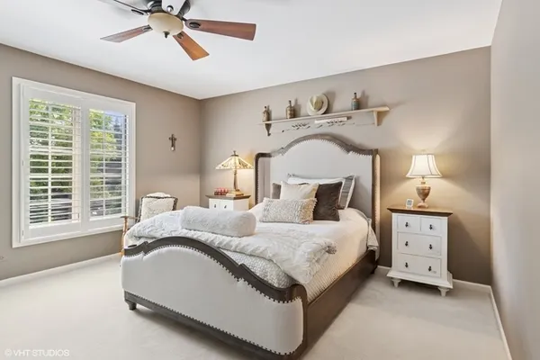 a spacious bedroom with a bed and a window