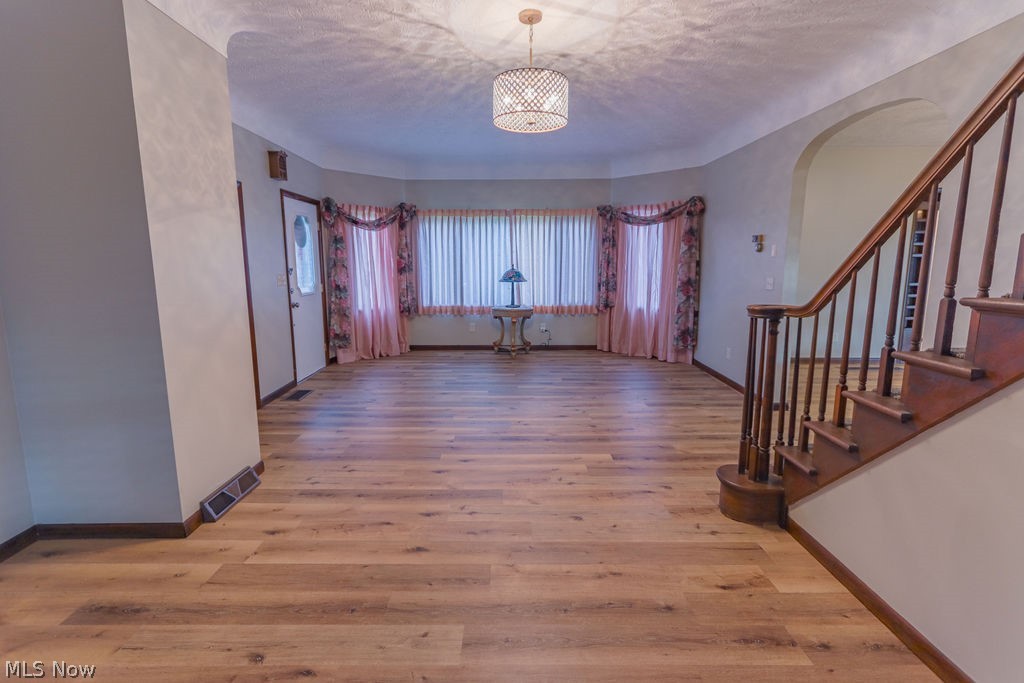 51883 Telegraph Road Amherst, OH 44001 - Photo 19 of 49 Entryway with a textured ceiling and light hardwood / wood-style flooring