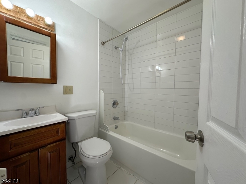 145 Smith Street, Unit 2F Elizabeth, NJ 07201 - Photo 12 of 17 a bathroom with a sink toilet and shower