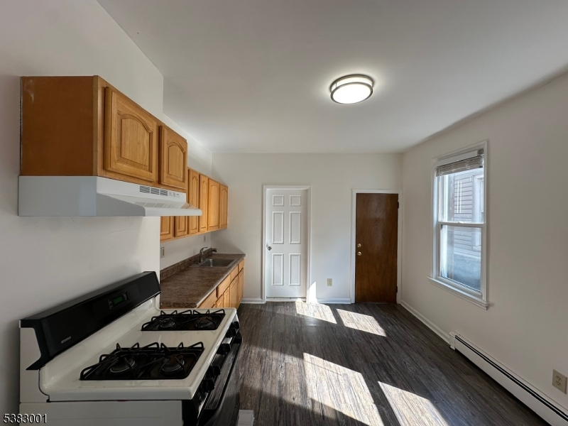 145 Smith Street, Unit 2F Elizabeth, NJ 07201 - Photo 7 of 17 a kitchen with a stove and a window