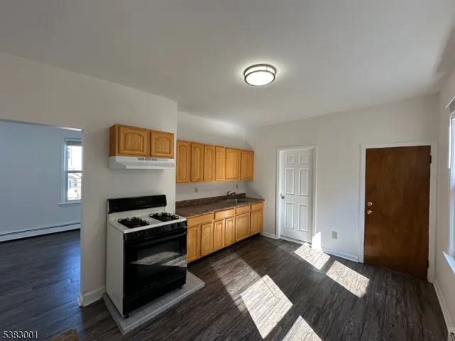 a kitchen with granite countertop a stove and a refrigerator
