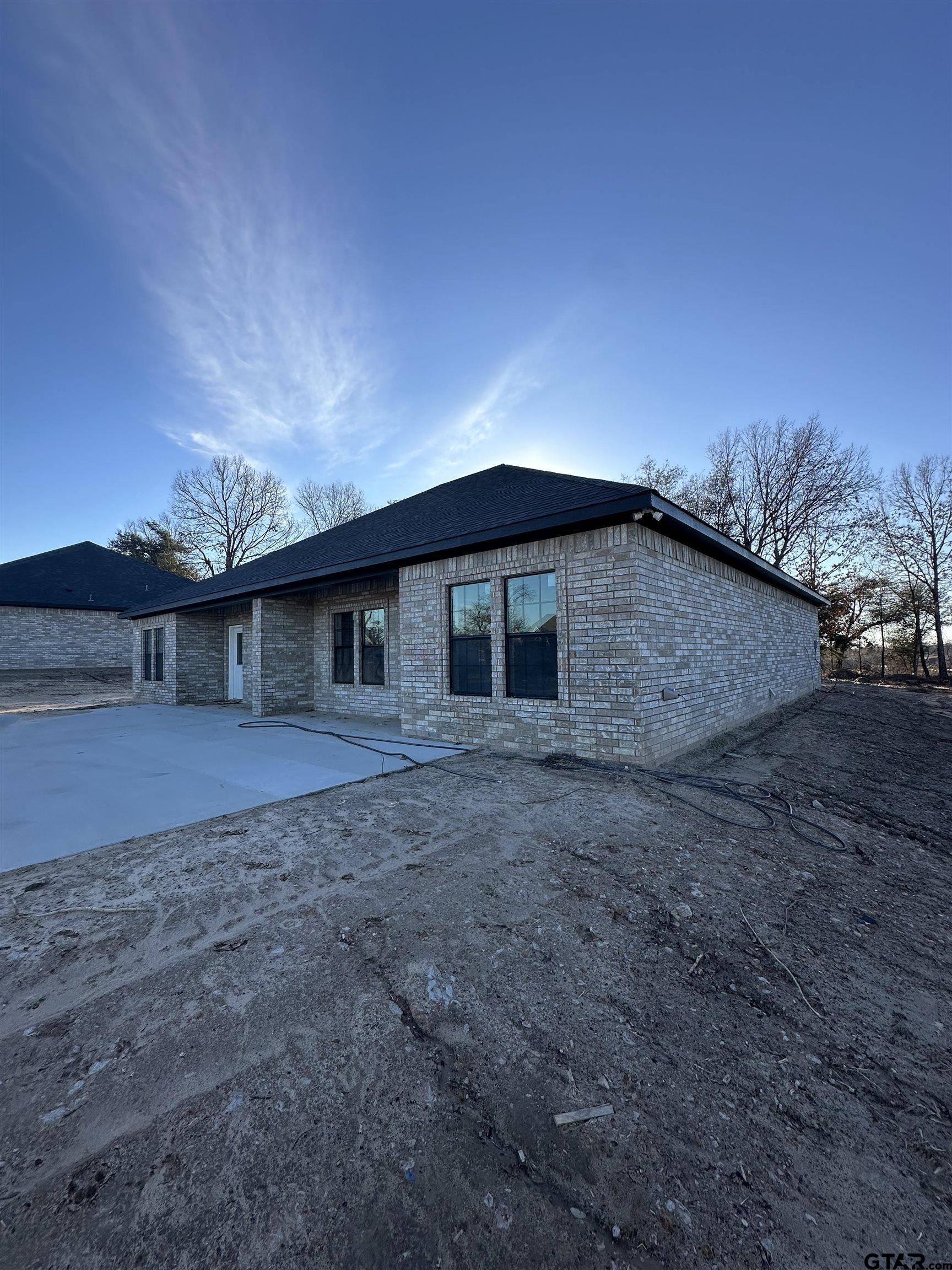 9839 County Road 35 Tyler, TX 75706 - Photo 11 of 12 a backyard of a house with table and chairs