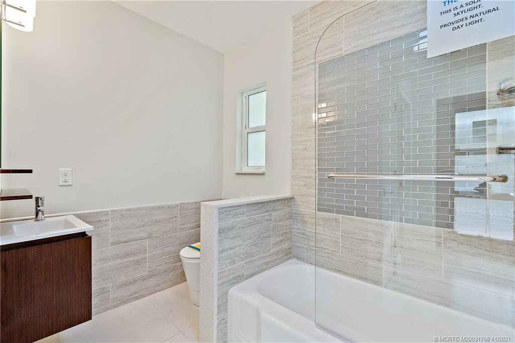 1037 Southeast Riverside Drive Stuart, FL 34996 - Photo 43 of 46 First Floor Front Guest (in-law suite) Full Bath