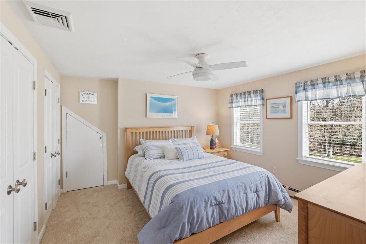 60 Harbor Hill Road Chatham, MA 02633 - Photo 25 of 47 a bedroom with a large bed and a desk