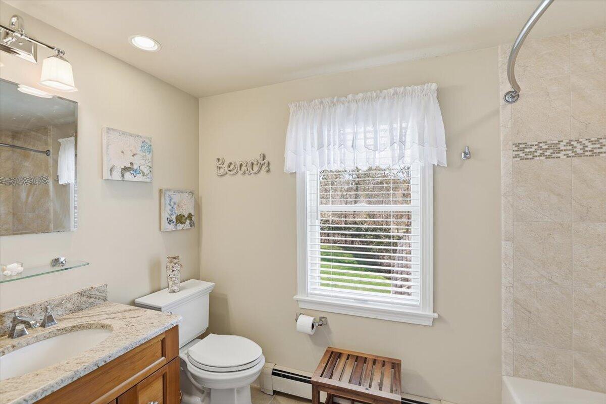 60 Harbor Hill Road Chatham, MA 02633 - Photo 28 of 47 a bathroom with a granite countertop toilet a sink a mirror and a window