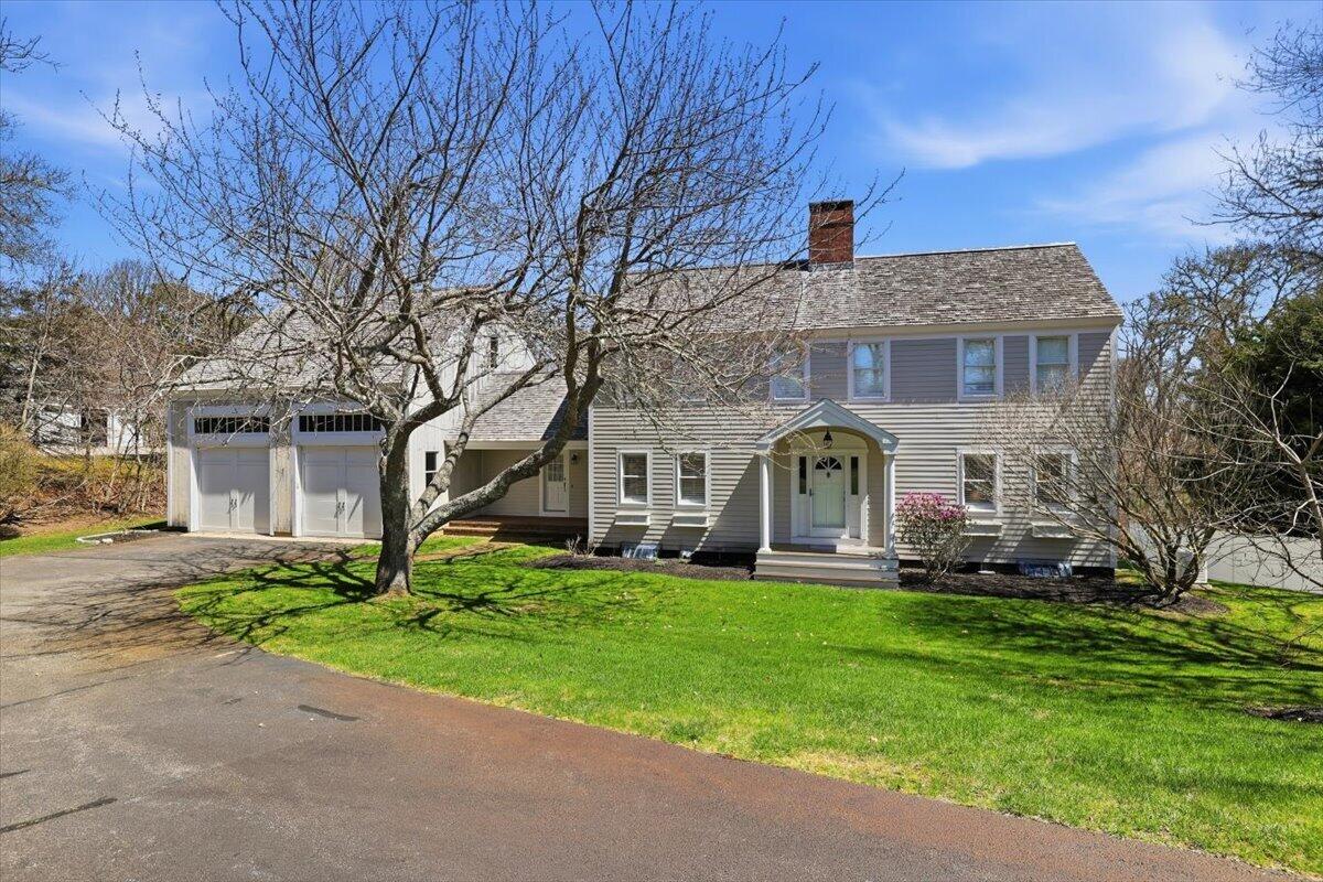 60 Harbor Hill Road Chatham, MA 02633 - Photo 37 of 47 a front view of a house with a yard and garage