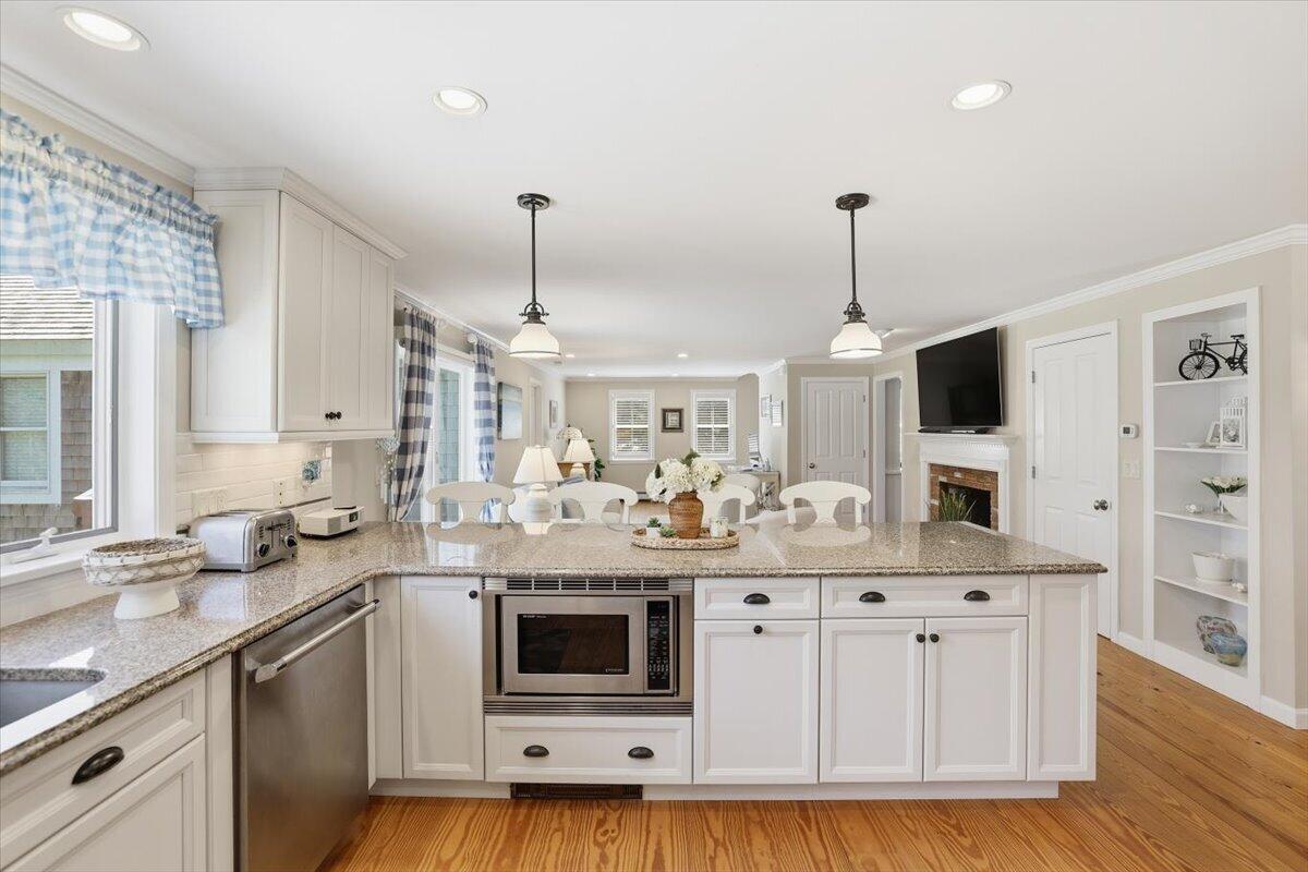 60 Harbor Hill Road Chatham, MA 02633 - Photo 8 of 47 a kitchen with stainless steel appliances kitchen island granite countertop a sink and a microwave