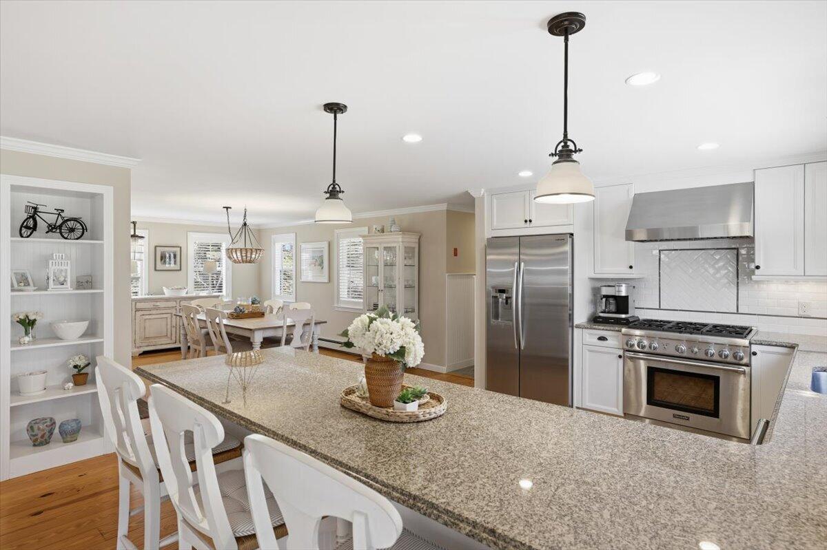 60 Harbor Hill Road Chatham, MA 02633 - Photo 9 of 47 a kitchen with stainless steel appliances granite countertop a sink a refrigerator a stove and white cabinets