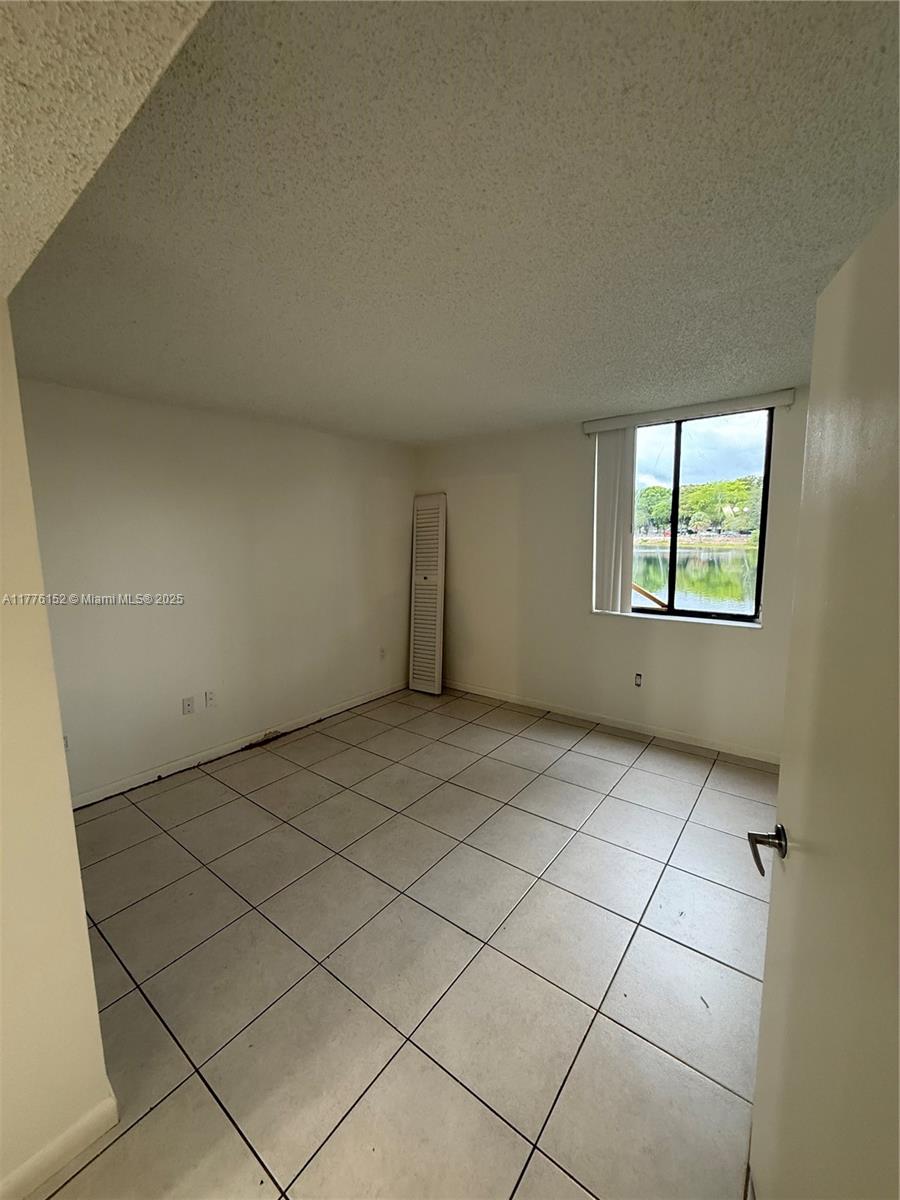 8335 Southwest 152nd Avenue, Unit B106 Miami, FL 33193 - Photo 11 of 27 an empty room with windows