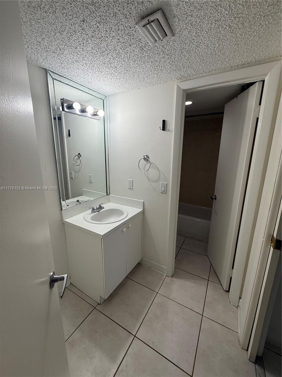 8335 Southwest 152nd Avenue, Unit B106 Miami, FL 33193 - Photo 13 of 27 a view of bathroom with a sink and mirror