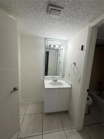 a white toilet sitting next to a bath tub