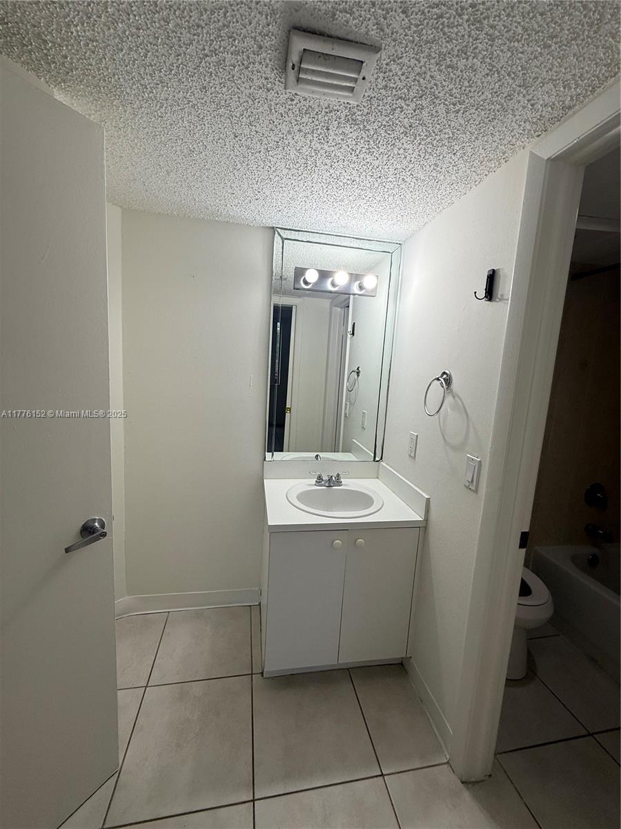 8335 Southwest 152nd Avenue, Unit B106 Miami, FL 33193 - Photo 14 of 27 a view of bathroom with a sink and mirror