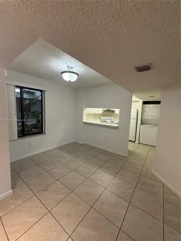 a kitchen with a refrigerator sink and cabinets