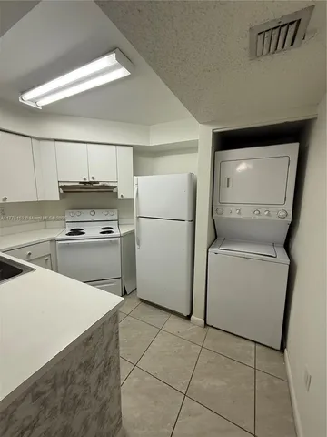 a kitchen with a stove a sink and a refrigerator