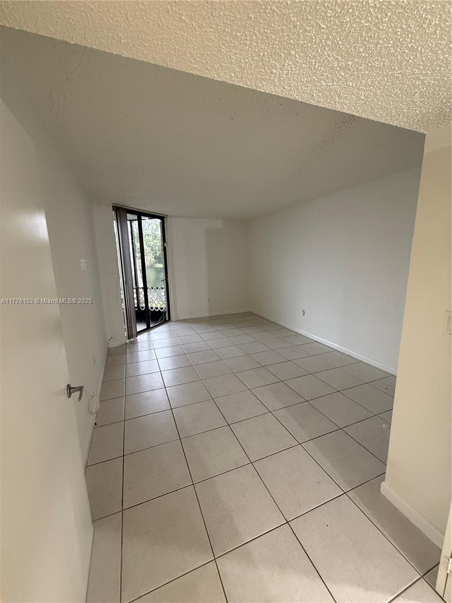 8335 Southwest 152nd Avenue, Unit B106 Miami, FL 33193 - Photo 19 of 27 a view of an empty room and window