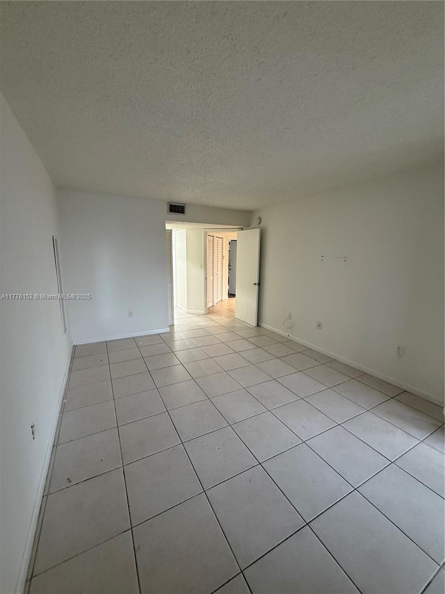 8335 Southwest 152nd Avenue, Unit B106 Miami, FL 33193 - Photo 20 of 27 a view of an empty room and window