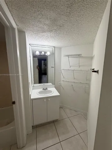 a white toilet sitting next to a bath tub