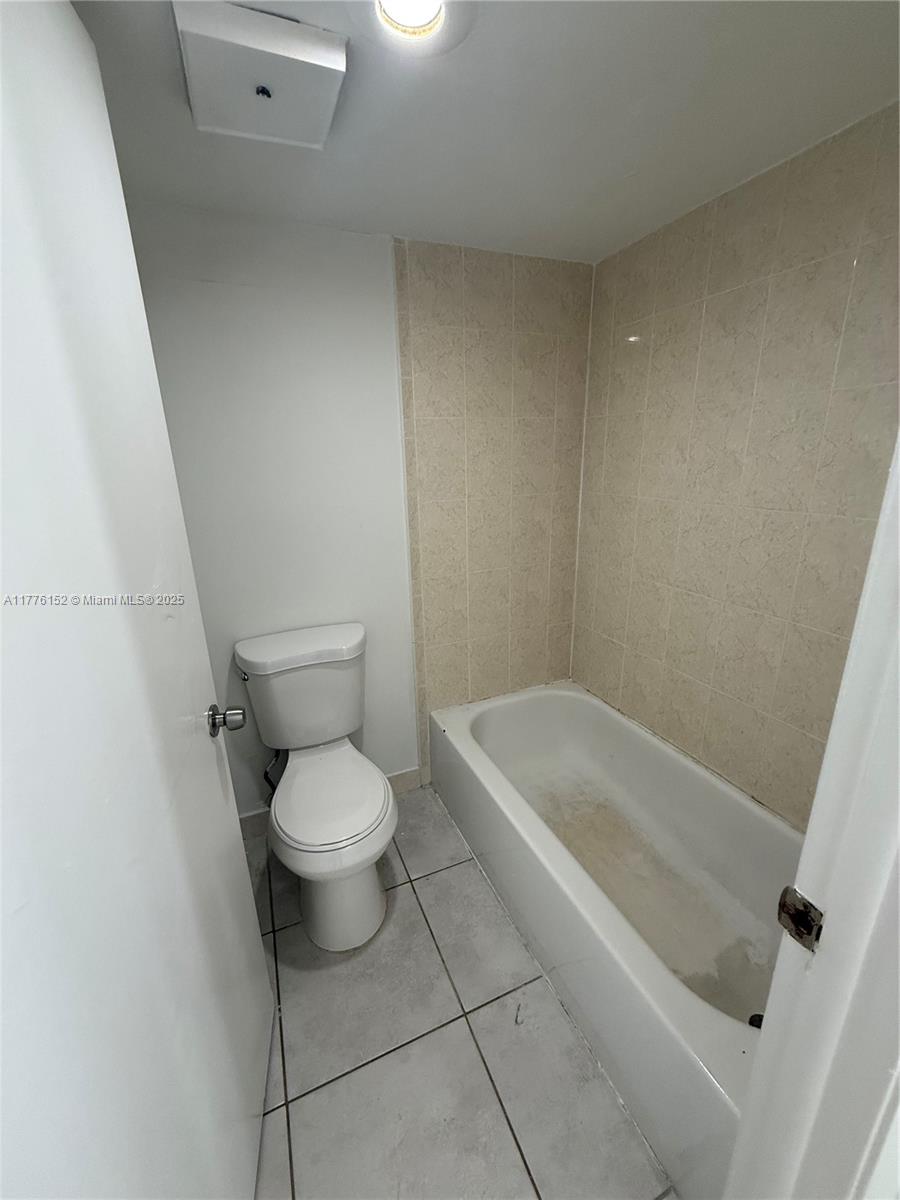 8335 Southwest 152nd Avenue, Unit B106 Miami, FL 33193 - Photo 23 of 27 a white toilet sitting next to a bath tub