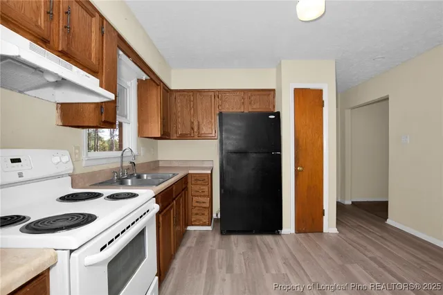 a kitchen with a sink stove and refrigerator
