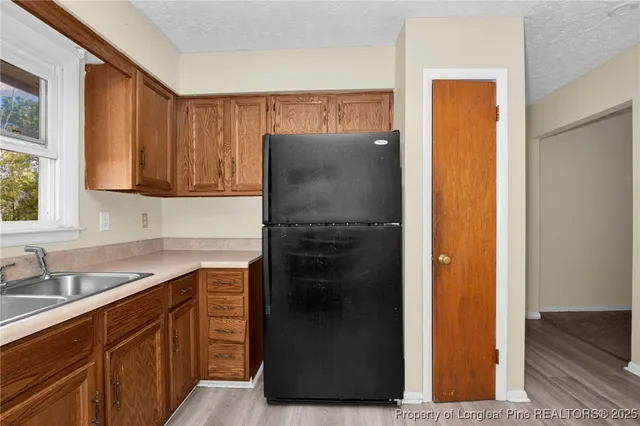 a kitchen with a refrigerator and a sink