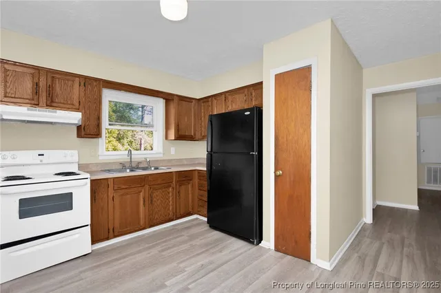 a kitchen with a refrigerator stove and sink