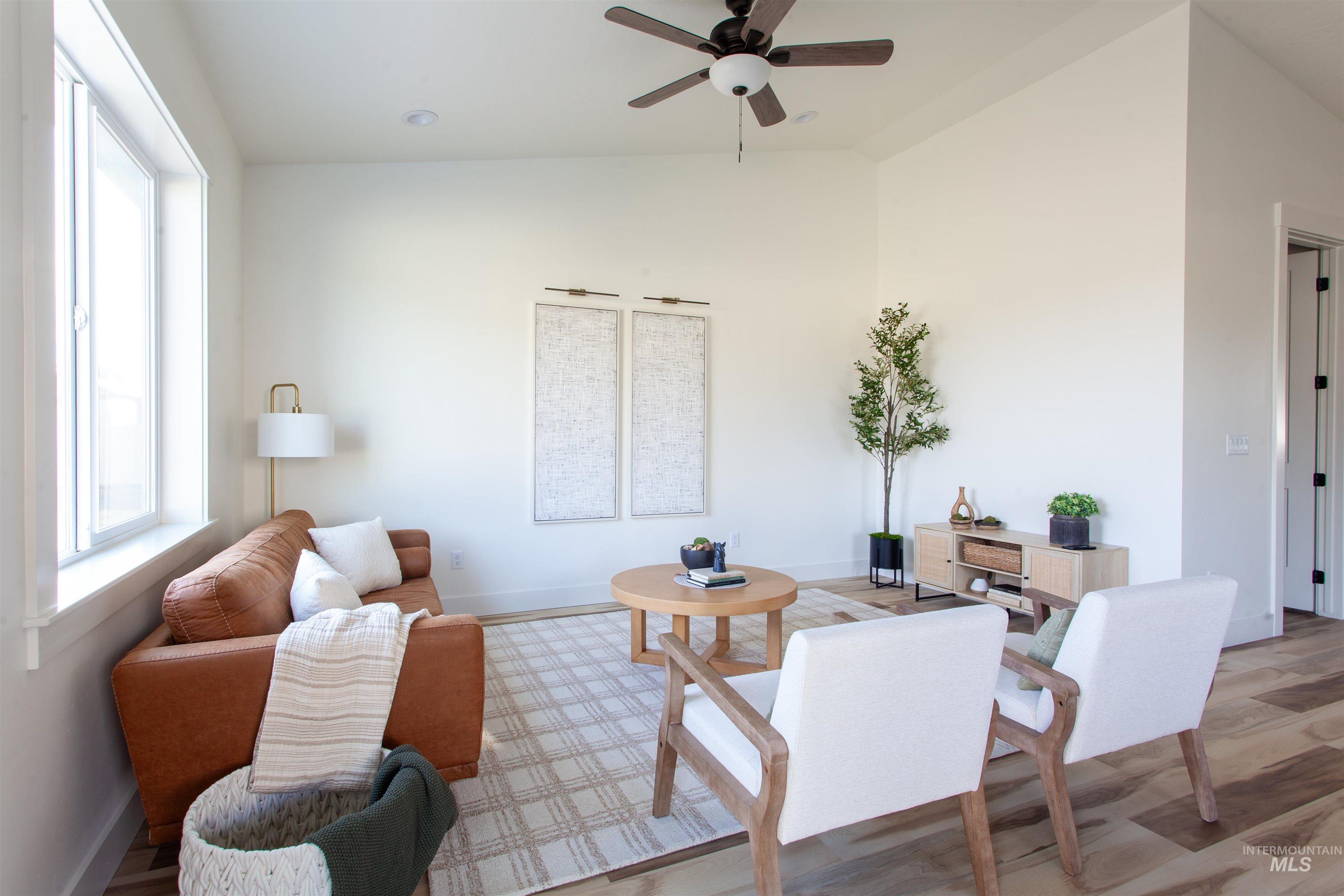 1113 Velvet Loop Wilder, ID 83676 - Photo 18 of 29 Living area featuring vaulted ceiling, wood finished floors, and ceiling fan