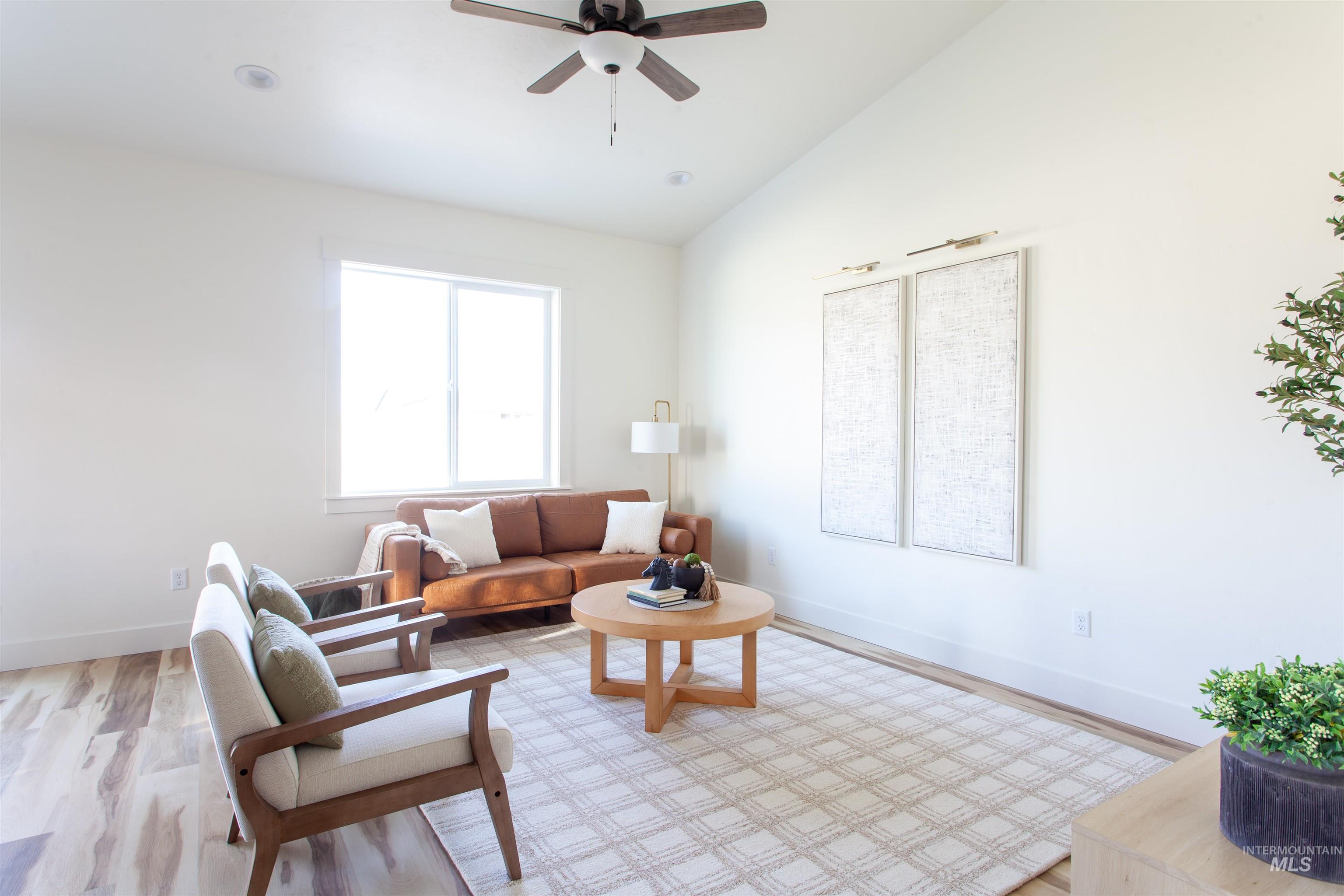 1113 Velvet Loop Wilder, ID 83676 - Photo 22 of 29 Living area with wood finished floors, lofted ceiling, and a ceiling fan