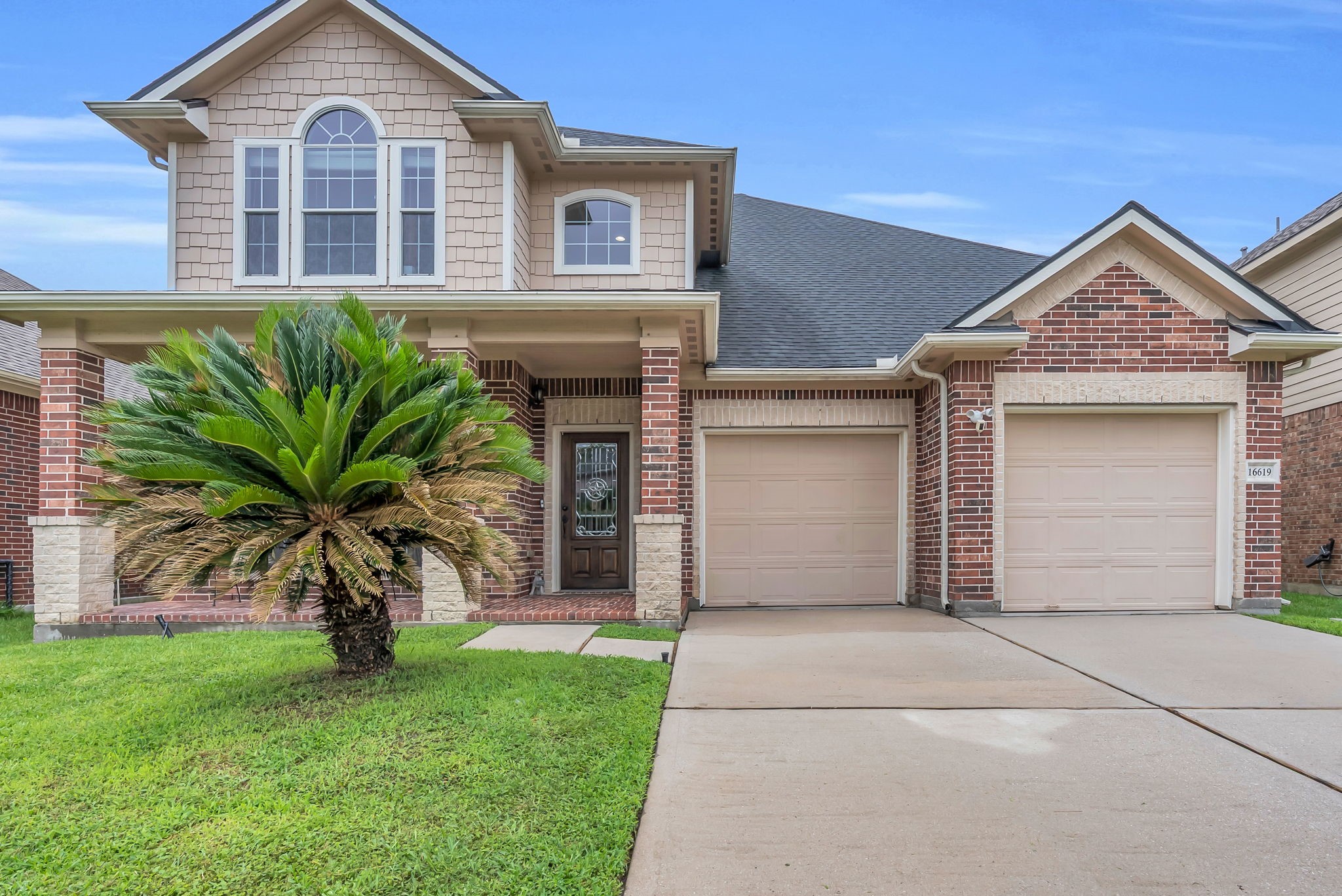 16619 Dover Mills Drive Spring, TX 77379 - Photo 2 of 49 a front view of a house with a garden and plants