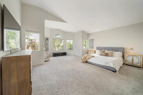 a large bedroom with a large bed and a large window