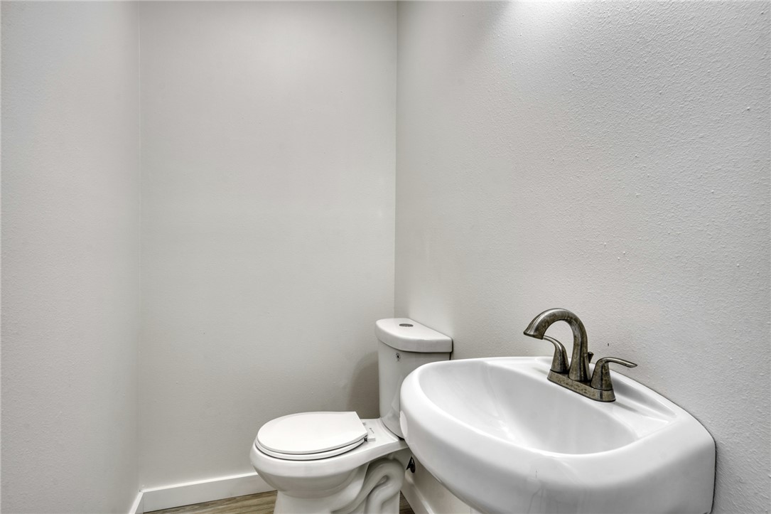 1513 Wolf Run College Station, TX 77840 - Photo 14 of 33 Half bath with a textured wall and wood finished floors