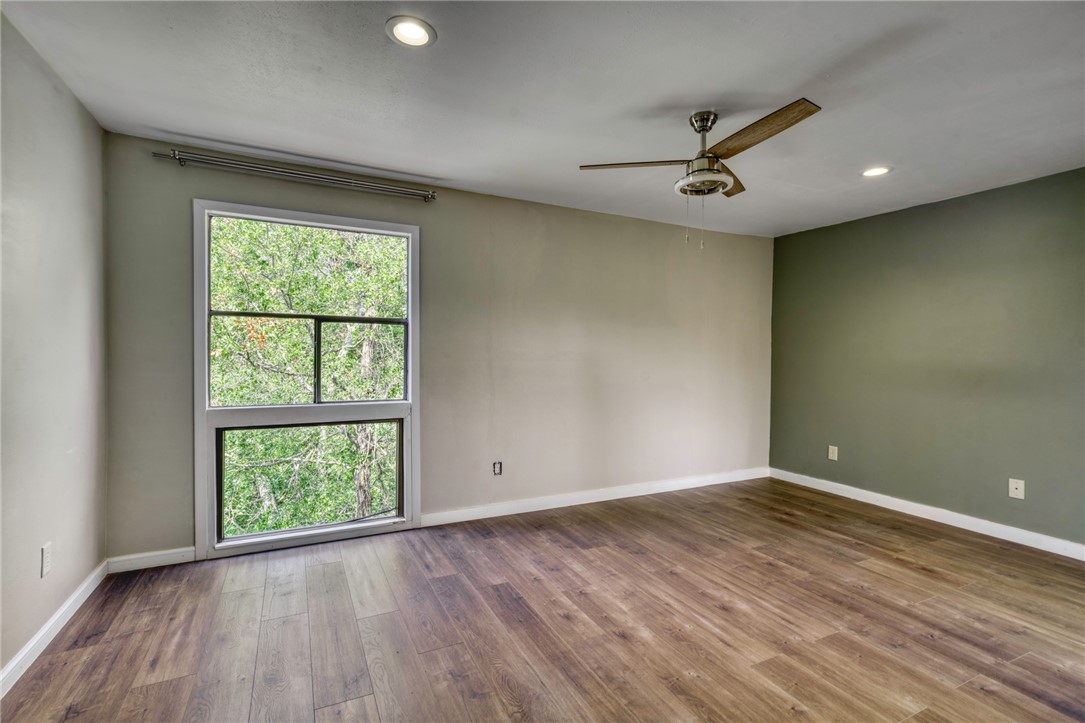 1513 Wolf Run College Station, TX 77840 - Photo 16 of 33 Primary room featuring recessed lighting, wood finished floors, and ceiling fan