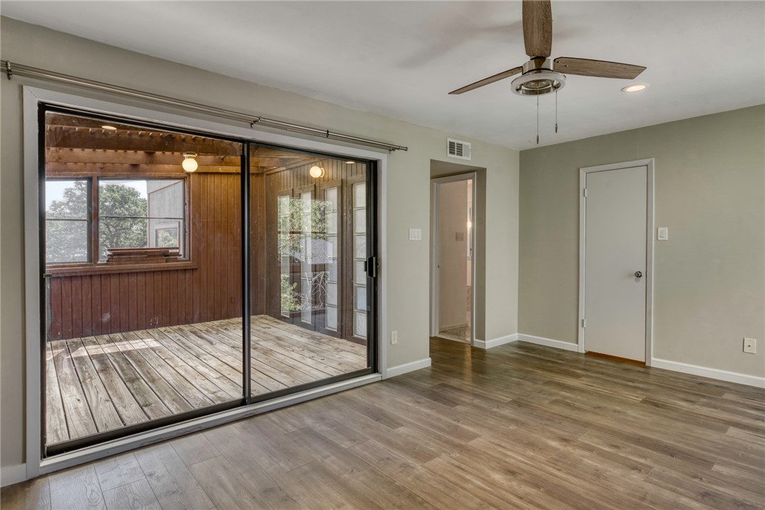 1513 Wolf Run College Station, TX 77840 - Photo 17 of 33 Doorway with wood finished floors, recessed lighting, and ceiling fan