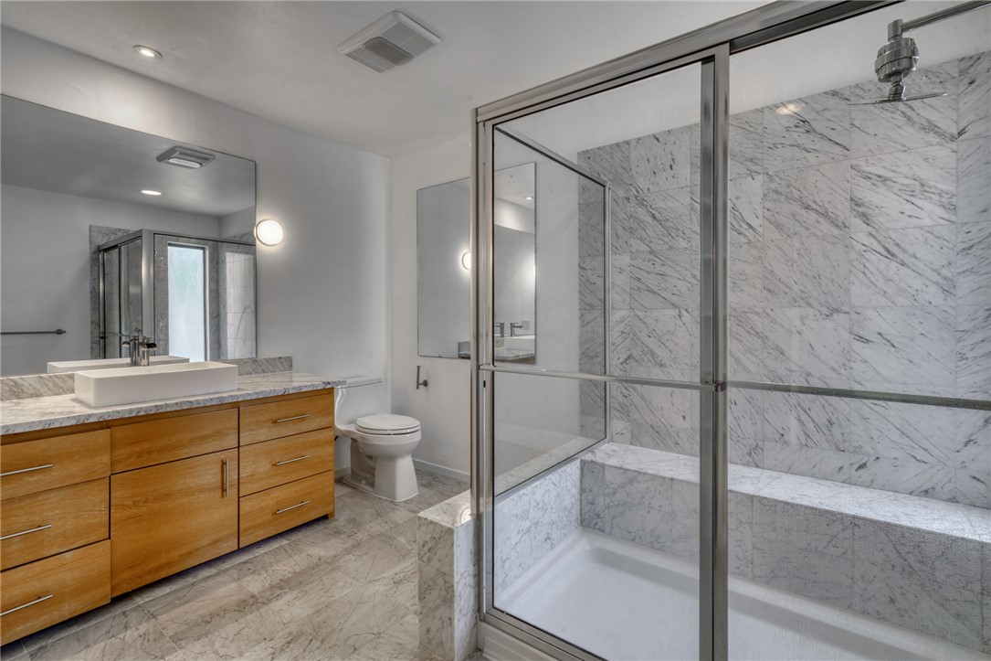 1513 Wolf Run College Station, TX 77840 - Photo 20 of 33 Full bathroom featuring vanity and a marble finish shower