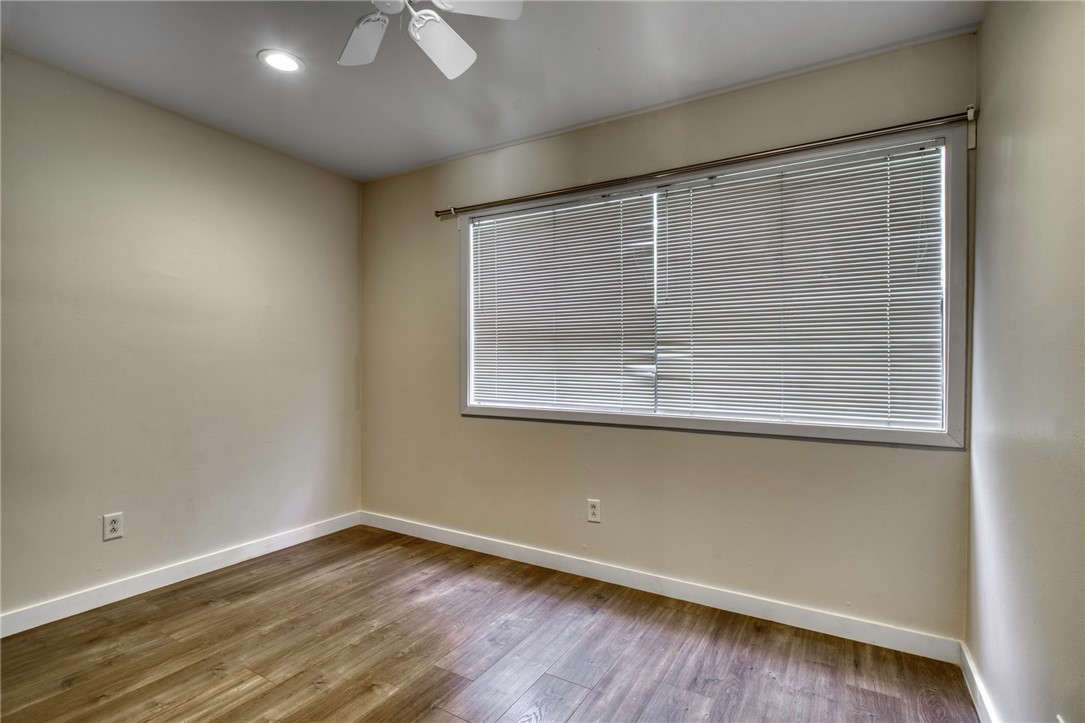 1513 Wolf Run College Station, TX 77840 - Photo 21 of 33 Empty room featuring wood finished floors, ceiling fan, and recessed lighting
