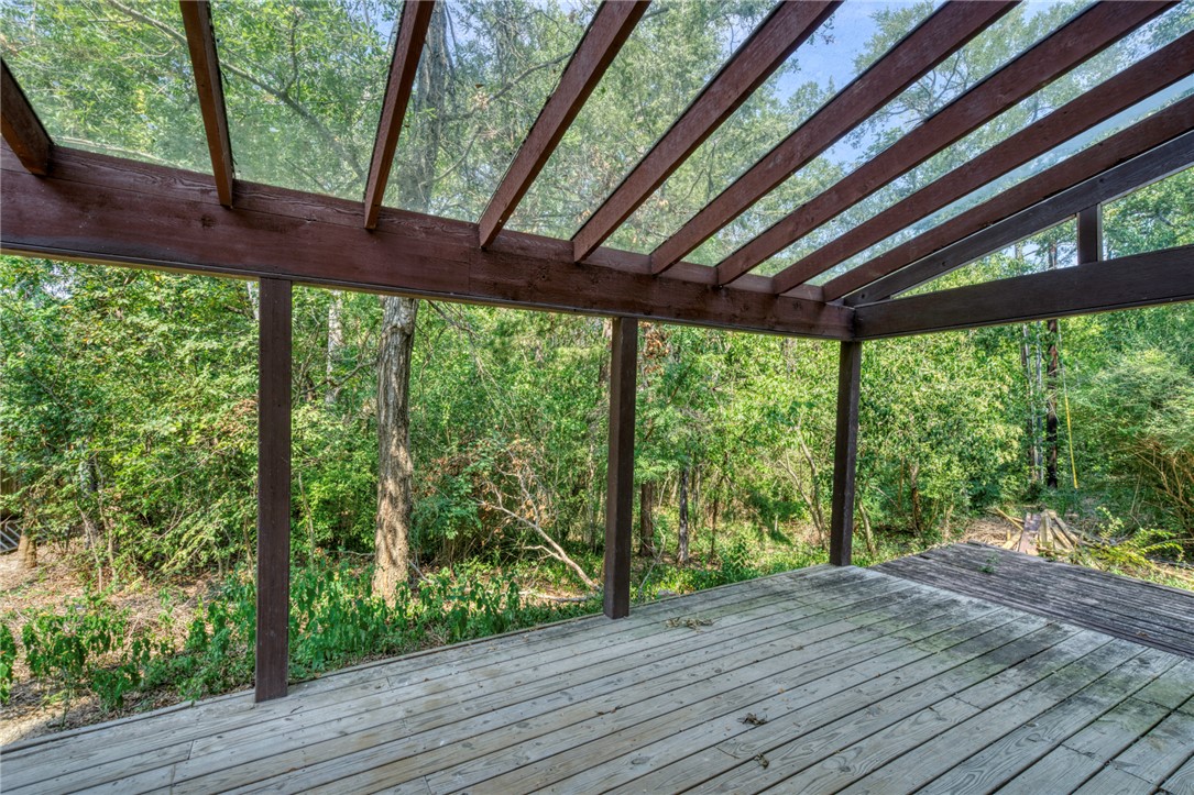 1513 Wolf Run College Station, TX 77840 - Photo 26 of 33 Wooden terrace featuring a forest view