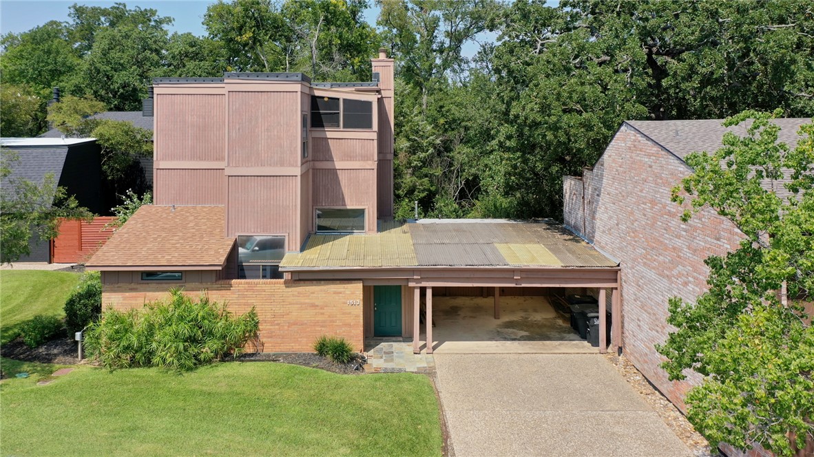 1513 Wolf Run College Station, TX 77840 - Photo 31 of 33 View of front of property with brick siding, driveway, a chimney, and a front lawn