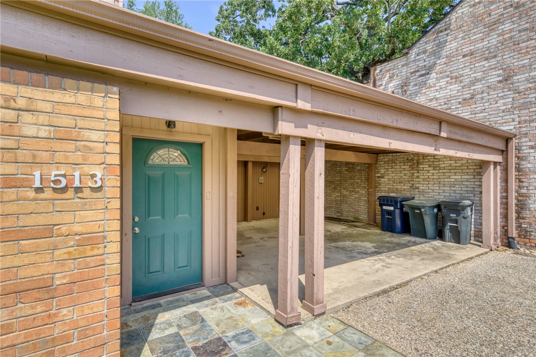 1513 Wolf Run College Station, TX 77840 - Photo 4 of 33 Doorway to property featuring a patio area and brick siding