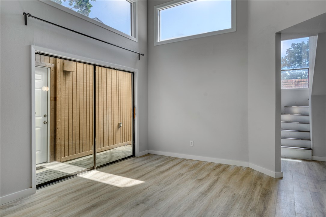1513 Wolf Run College Station, TX 77840 - Photo 8 of 33 Unfurnished room with light wood-type flooring and a towering ceiling
