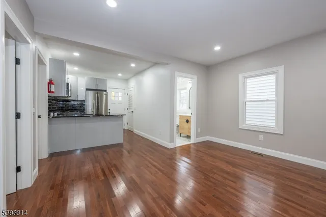 a view of a kitchen with a sink a refrigerator and window
