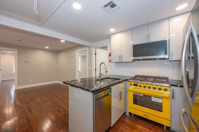 a kitchen with a sink stove and microwave
