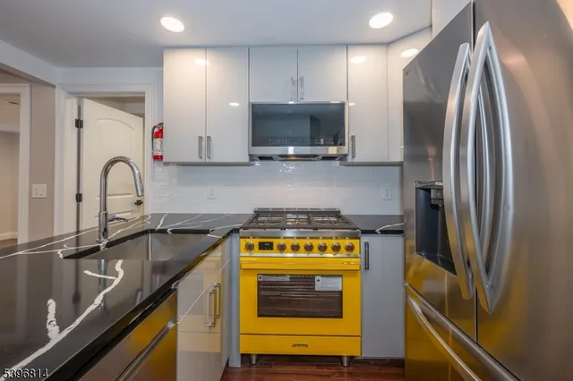 a kitchen with a sink a stove and refrigerator