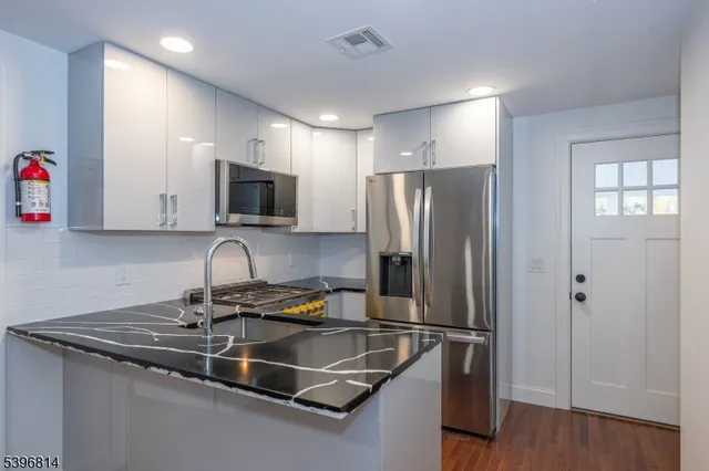 a kitchen with a refrigerator sink and microwave